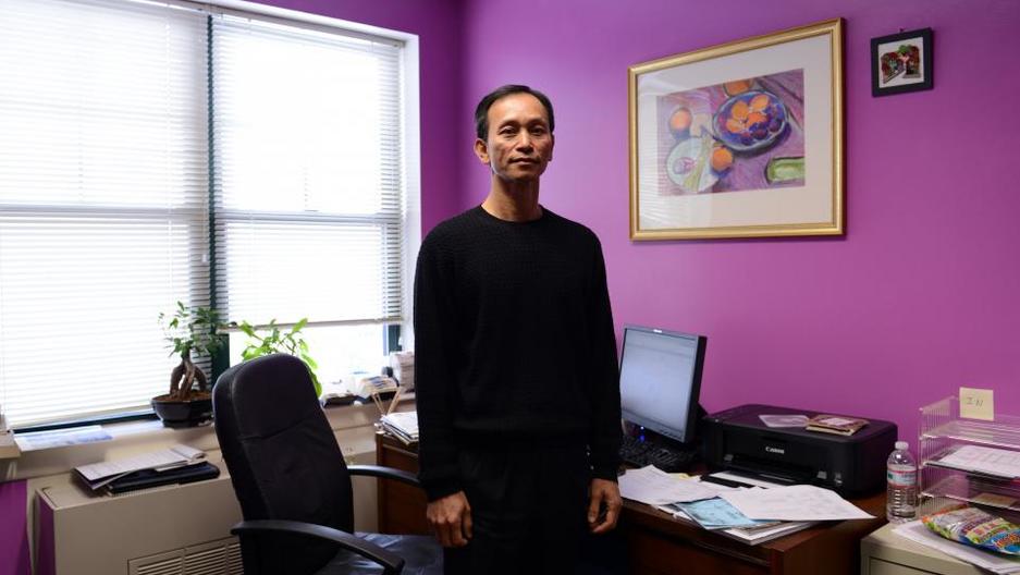Man standing in front of desk